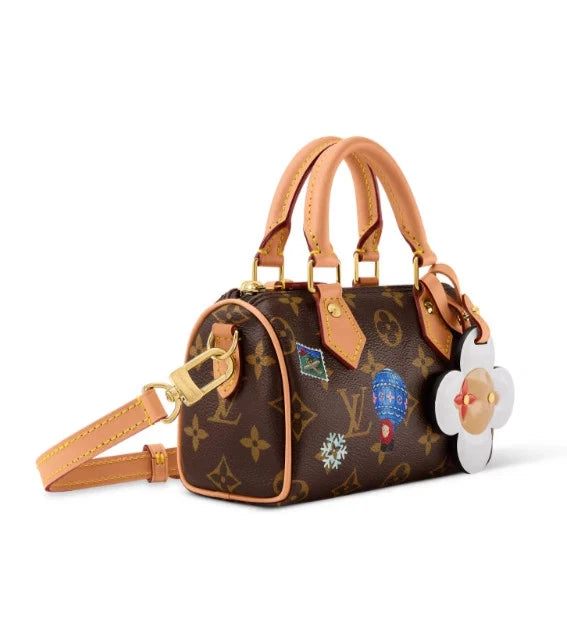 Nano Speedy in Monogram Snowy Pearl, three-quarter side with strap and charm reference view