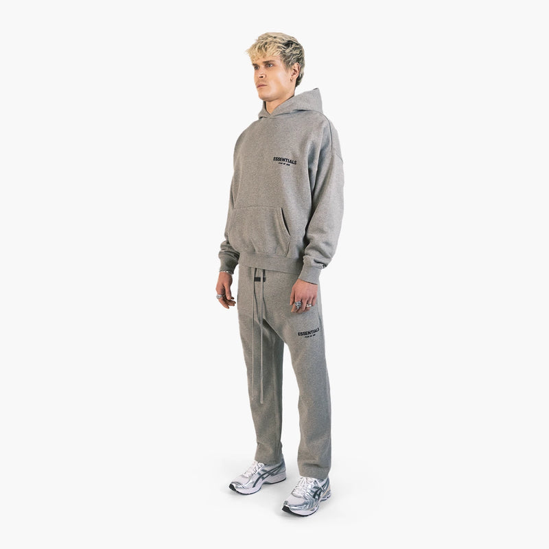 Fear of God Essentials Relaxed Sweatpants Dark Oatmeal — model three-quarter side; styling items are not included