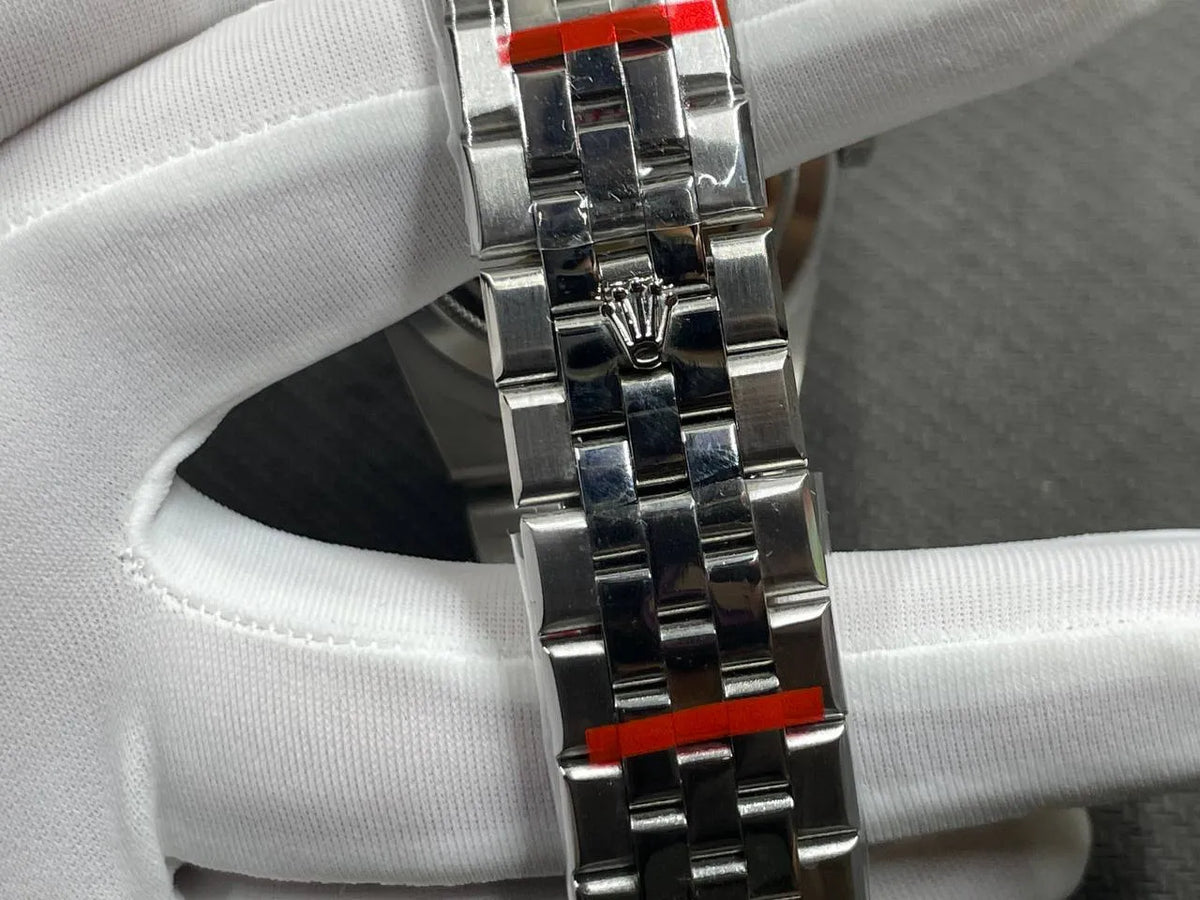 Rolex Land-Dweller Ice Blue Honeycomb Dial Flat Jubilee Bracelet, closed Flat Jubilee clasp held in white gloves