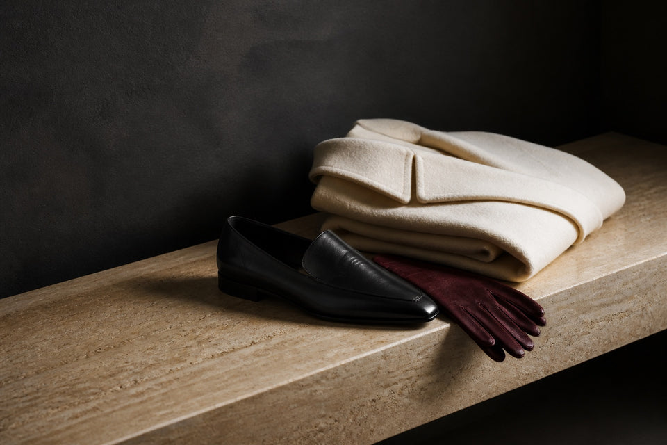 Shoes and wardrobe accessories on a stone surface